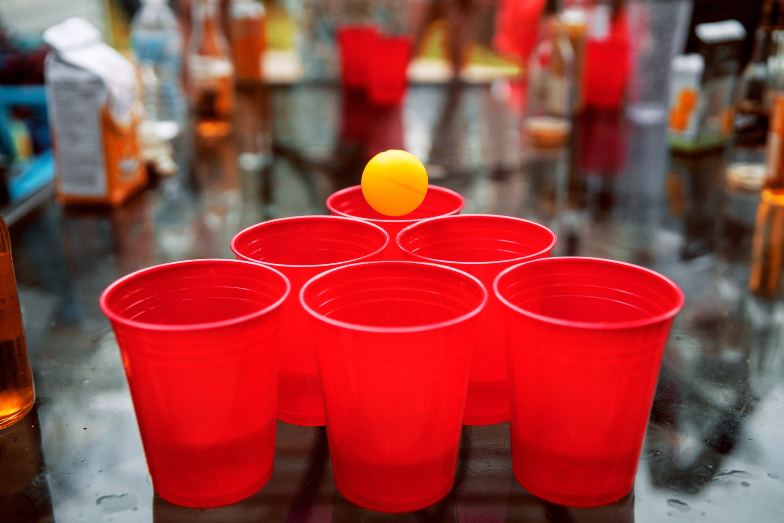 Prosecco pong cups arranged on a long dining table
