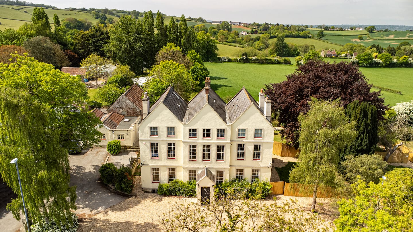 Aerial view of the manor set among trees and fields