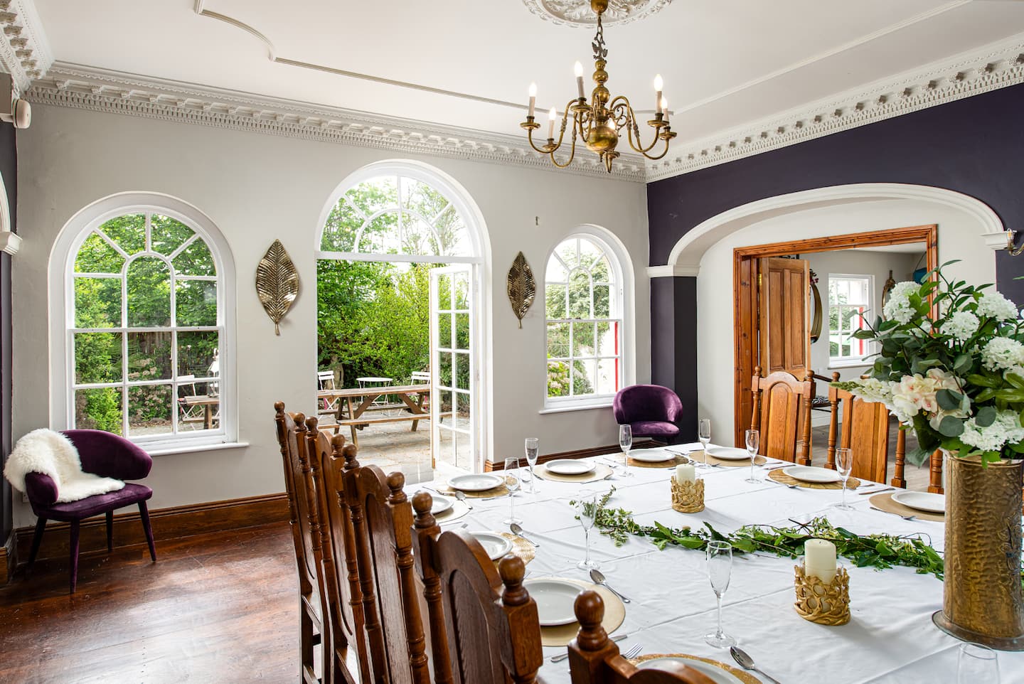 Reception room with arched windows and a table set for the group