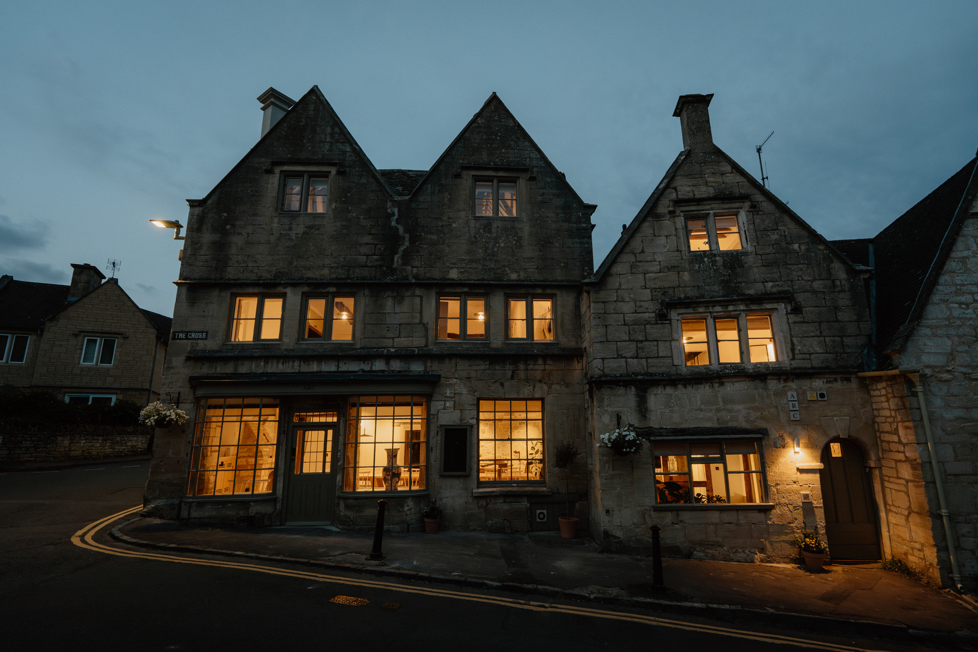 The Honeystone Manor, 15th century Cotswolds hen party manor house lit up at dusk