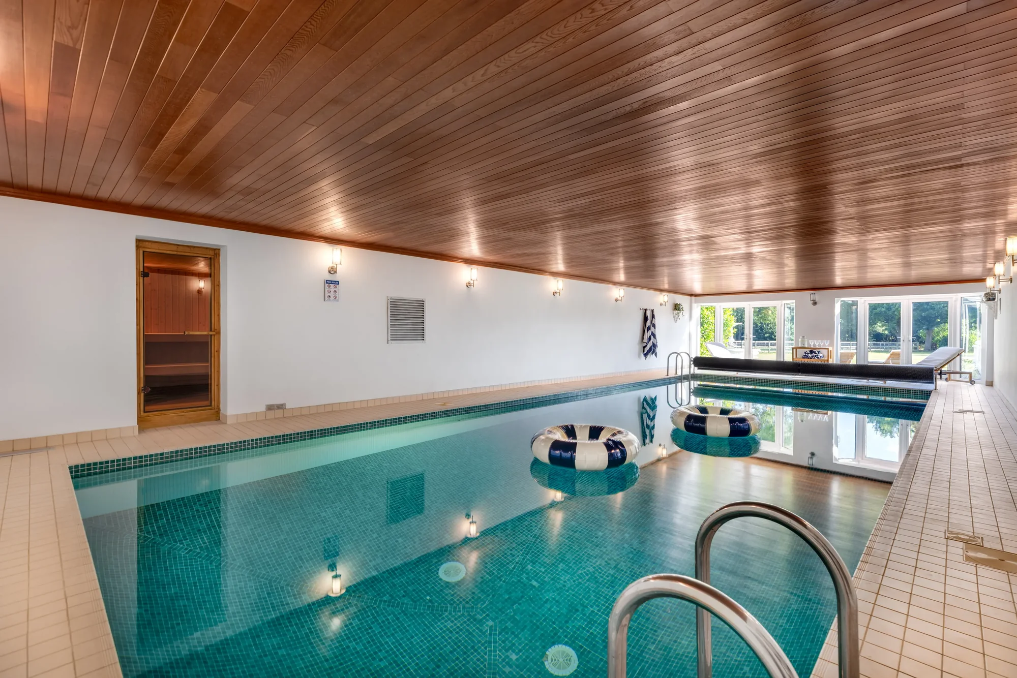 Indoor swimming pool with wood-clad ceiling and sauna alongside, The Lakeside Retreat