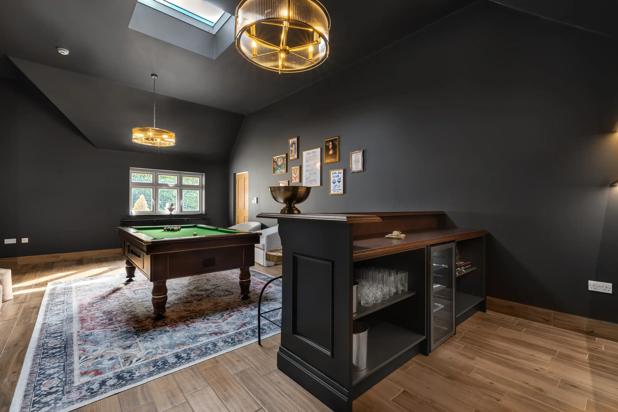 Black-walled games room with green-baize pool table, bar counter and brass pendant lights, The Lakeside Retreat