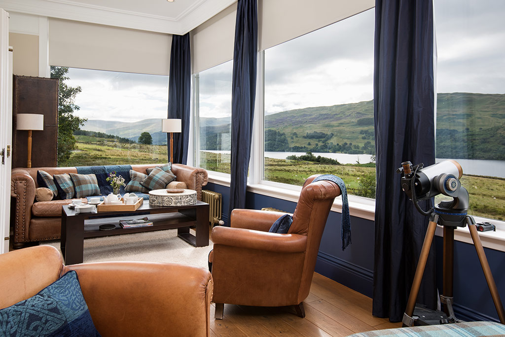 Snug with leather sofas, telescope on a tripod and floor-to-ceiling windows looking onto Loch Tay