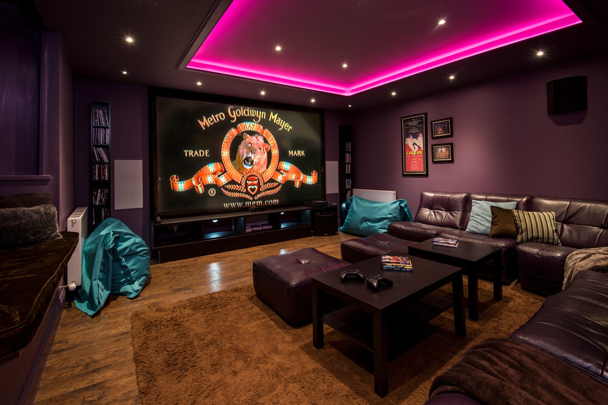 Cinema room with pink LED ceiling, big screen showing MGM logo, leather sofas and beanbags, Sequoia House