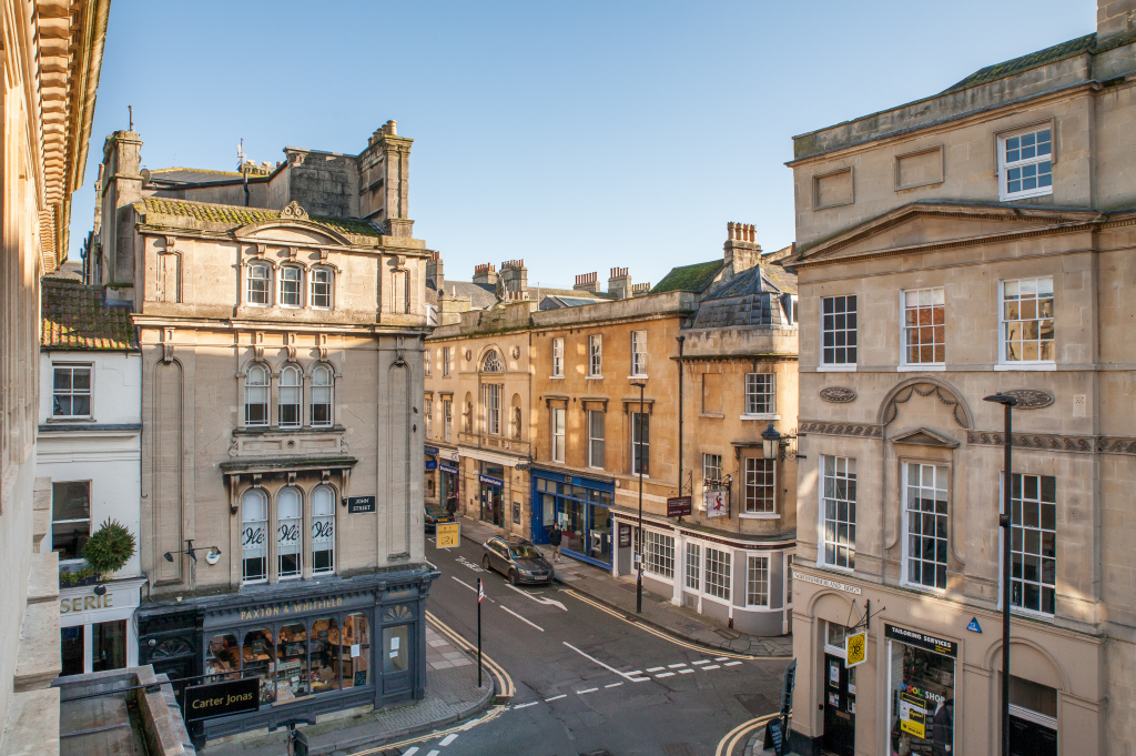 View from a Tillie's window over Bath stone shopfronts and the rooftops, central Bath