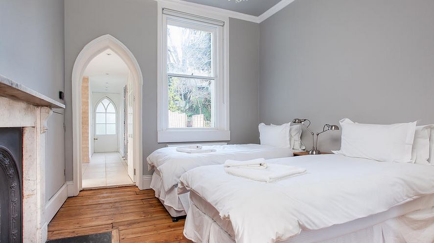 Twin bedroom with gothic arched doorway, marble fireplace and period sash window, Victorian Townhouse