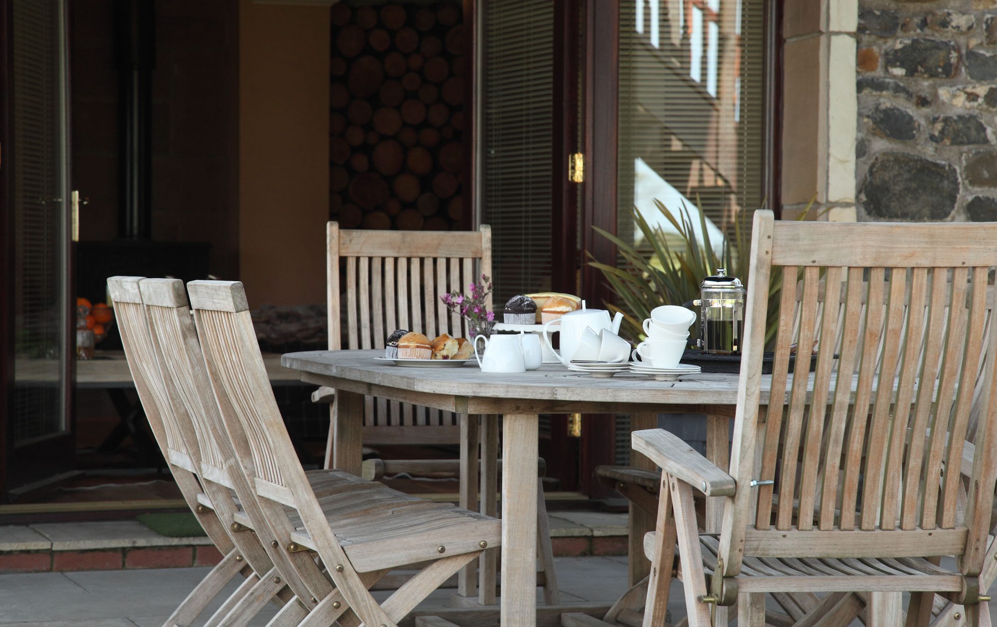 Outdoor terrace afternoon tea with scones, cake and cafetière at Writers Retreat
