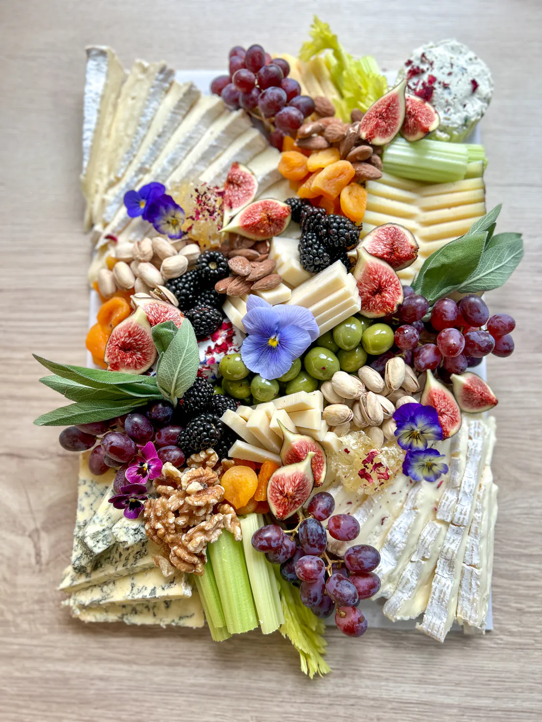 Three Little Figs grazing platter — cheeses, figs, grapes, olives, walnuts and edible flowers