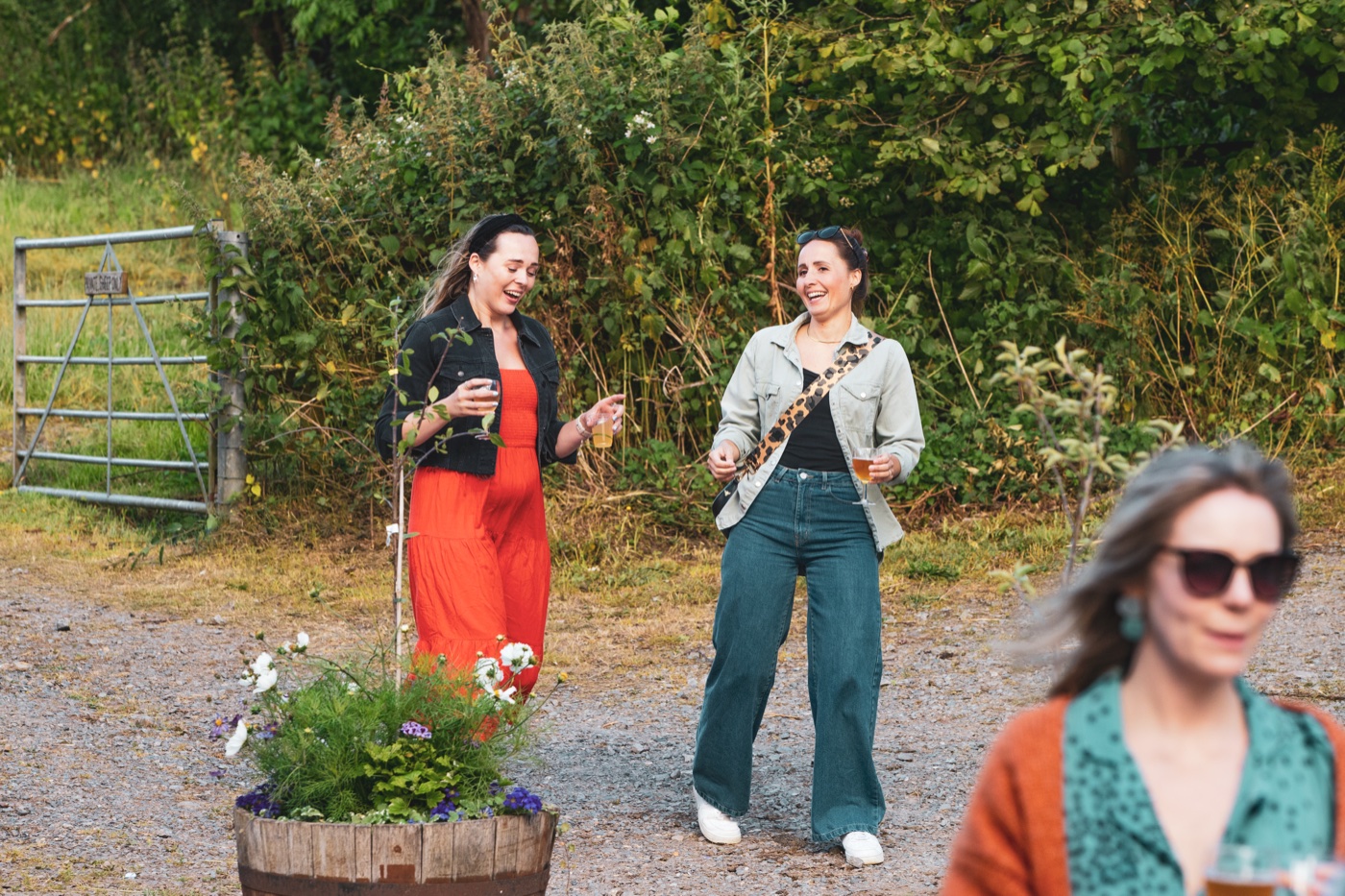 Hens laughing with drinks in hand at Wild West Wines organic farm tasting near Bath