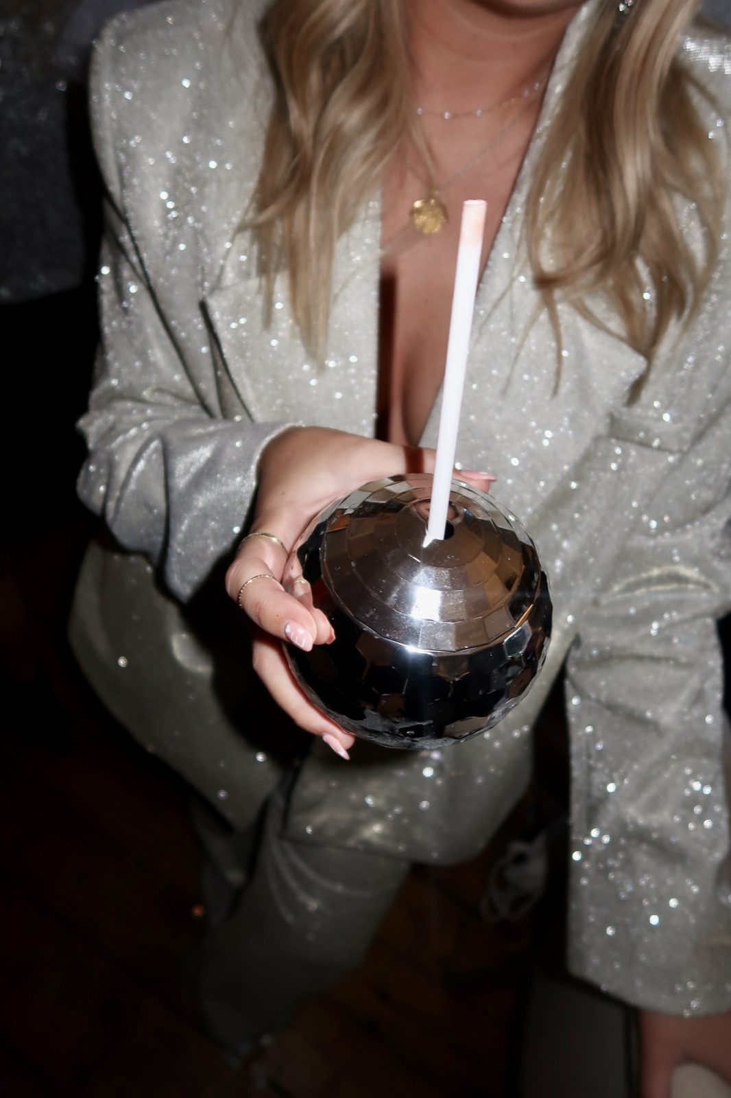 Hen guest in a sparkly blazer holding a silver disco-ball cocktail glass, Edinburgh