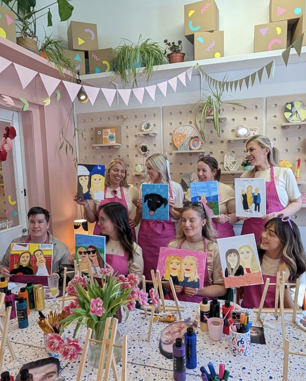 Hen group painting portraits of the groom over drinks
