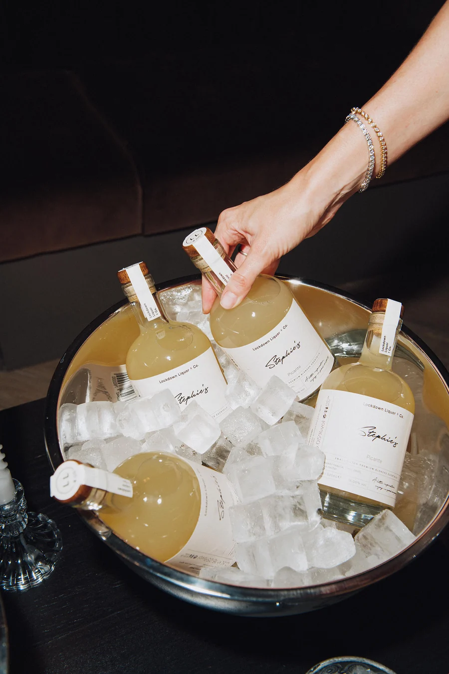 Personalised Lockdown Liquor & Co. cocktail bottles chilling in an ice bucket